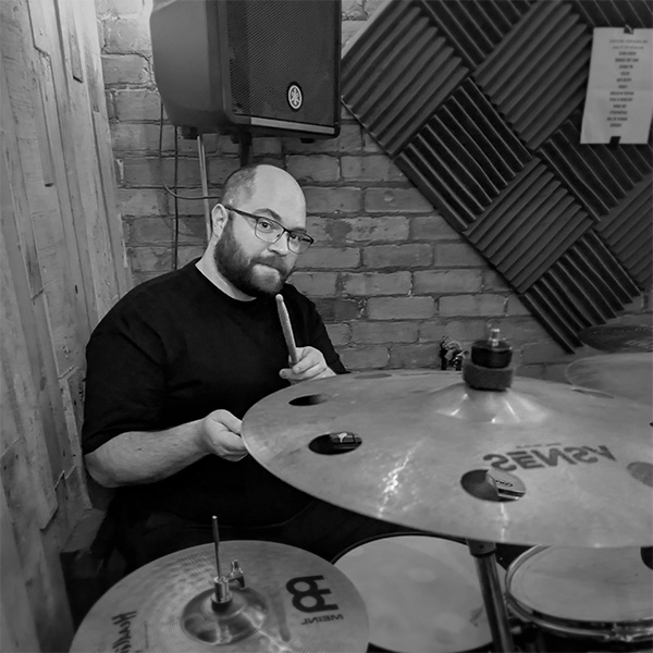 Piotr Ignatowicz at his drumkit in the One Dimensional Creatures practice room in 2025